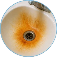 Orange iron staining in a bathroom sink basin